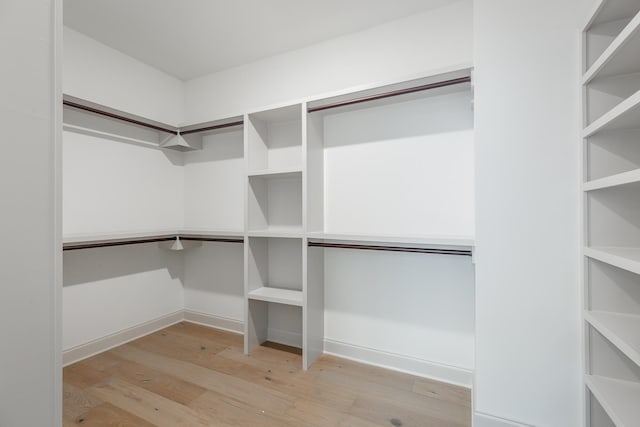 walk in closet featuring light hardwood / wood-style flooring