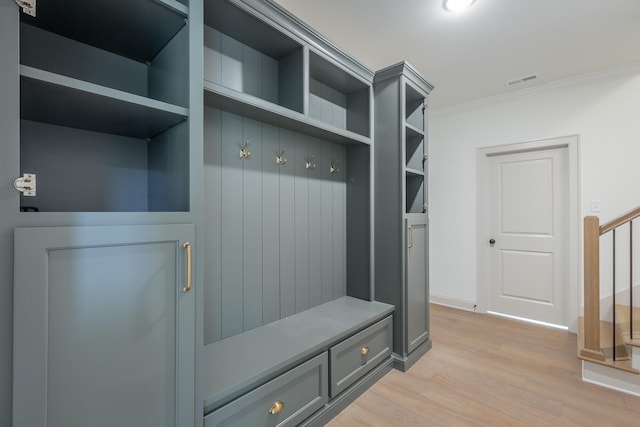 mudroom with crown molding and light wood-type flooring