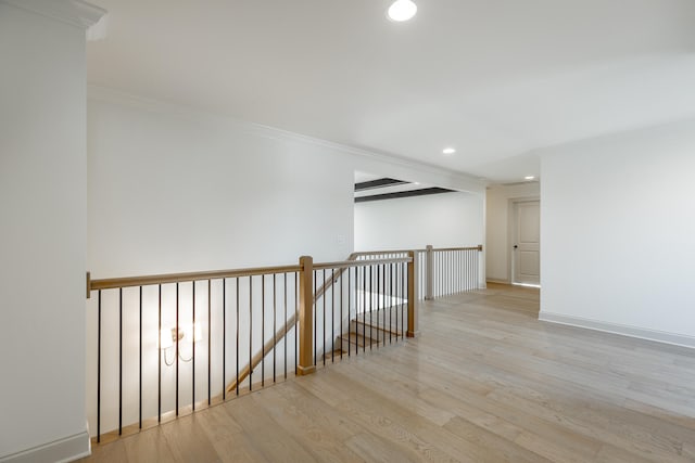 unfurnished room with light wood-type flooring and ornamental molding