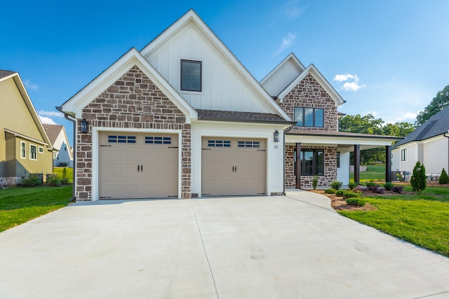 craftsman-style home with a garage and a front lawn