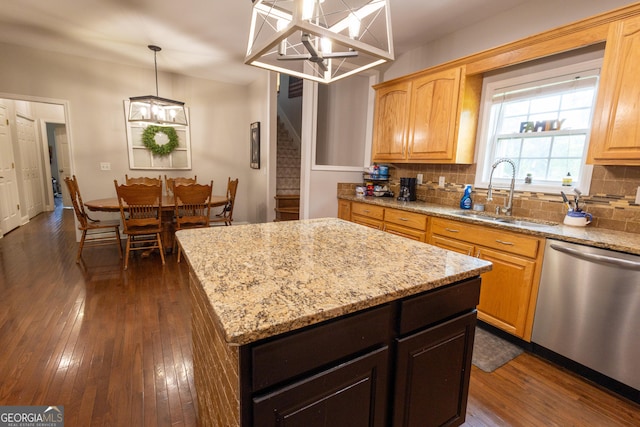 kitchen featuring dark hardwood / wood-style flooring, dishwasher, a center island, sink, and a chandelier