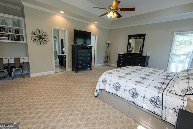 bedroom featuring crown molding, ceiling fan, ensuite bath, and light carpet