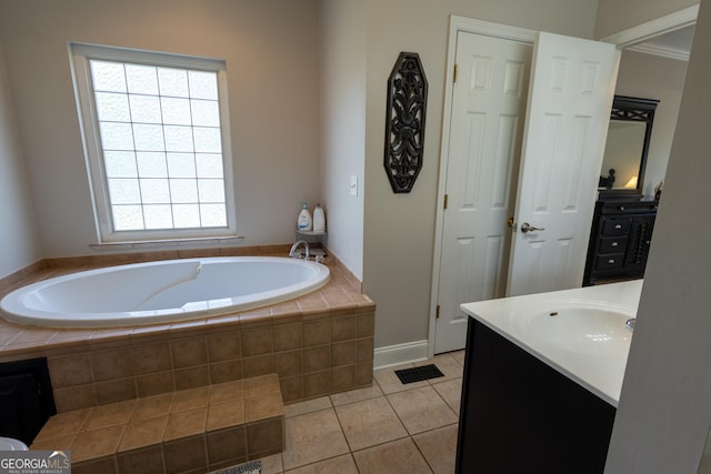 bathroom featuring vanity, tile patterned floors, and tiled bath