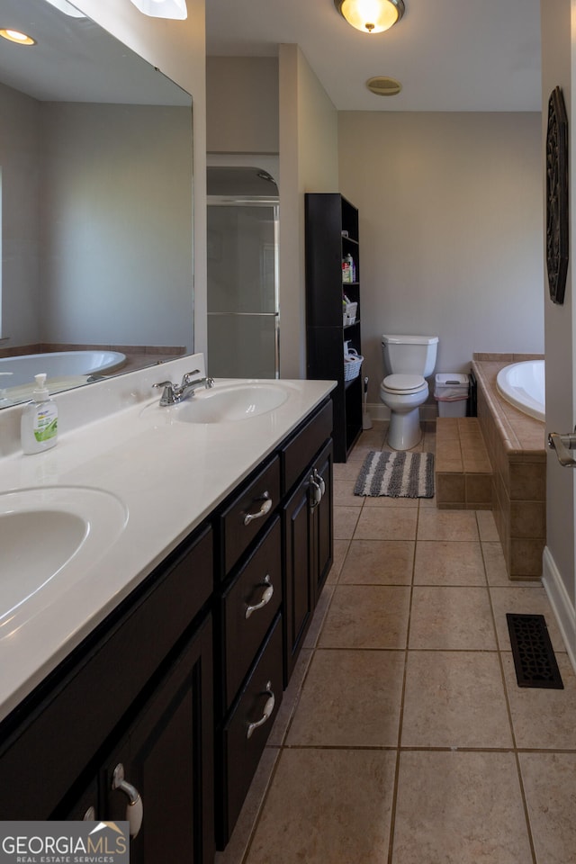 full bathroom featuring vanity, toilet, shower with separate bathtub, and tile patterned flooring