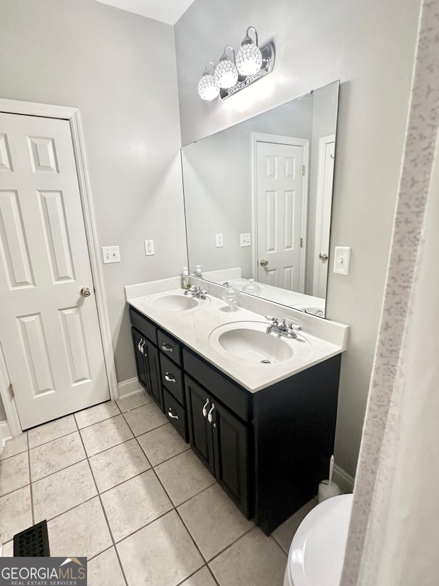 bathroom featuring tile patterned flooring, toilet, and vanity