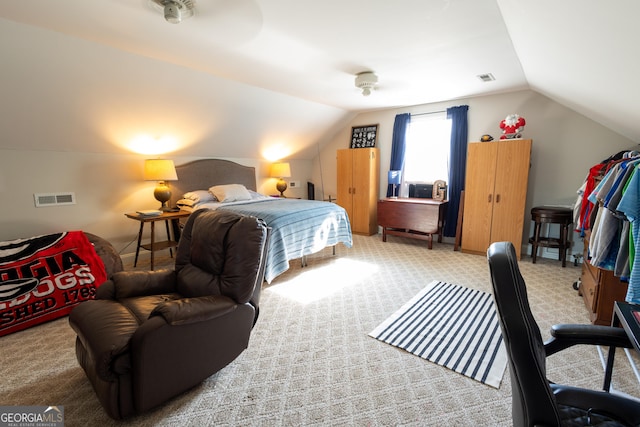 bedroom featuring vaulted ceiling and carpet floors