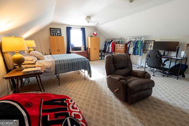 bedroom with lofted ceiling and carpet