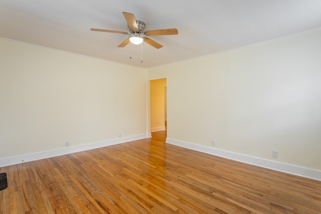 empty room featuring crown molding, light hardwood / wood-style flooring, and ceiling fan