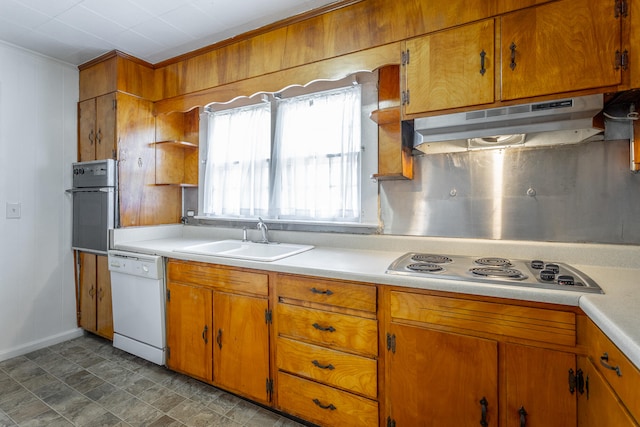 kitchen with wall oven, dishwasher, sink, ornamental molding, and stainless steel cooktop