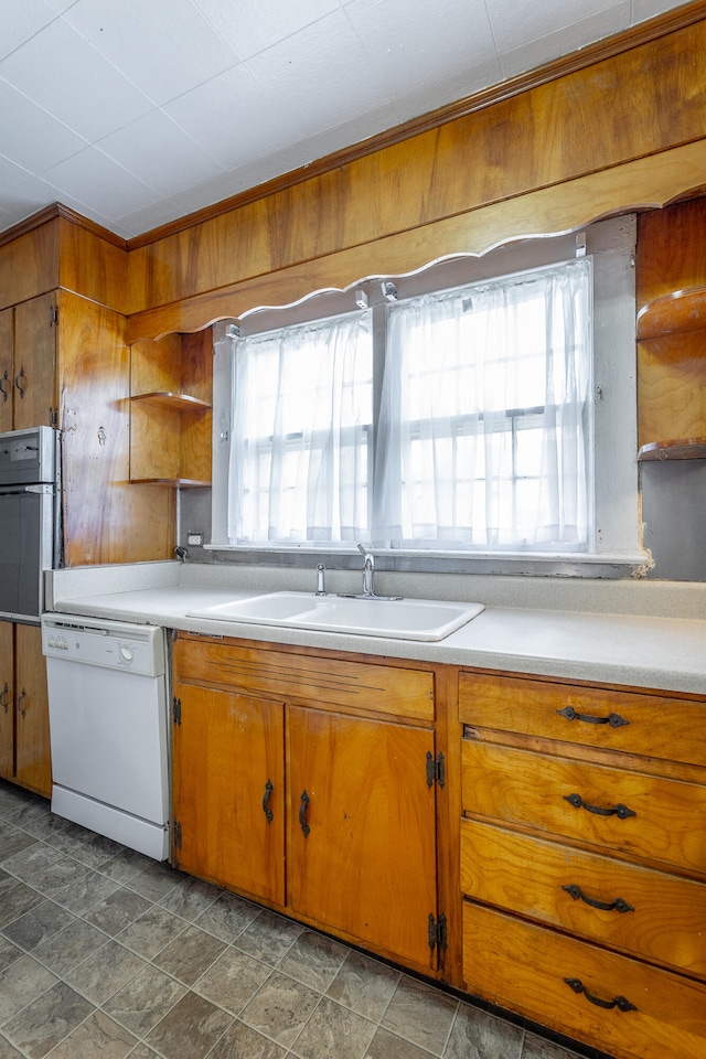 kitchen featuring dishwasher, stainless steel oven, and sink