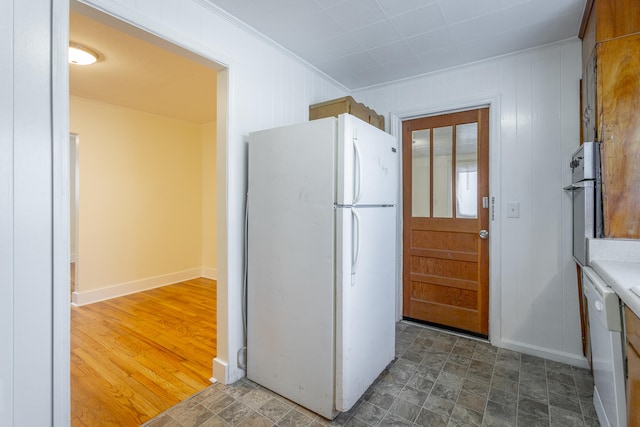 kitchen featuring hardwood / wood-style floors, white appliances, and ornamental molding