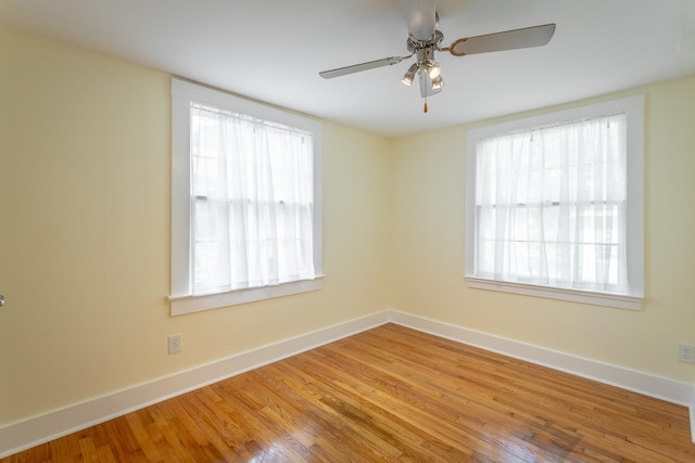 empty room with wood-type flooring and ceiling fan