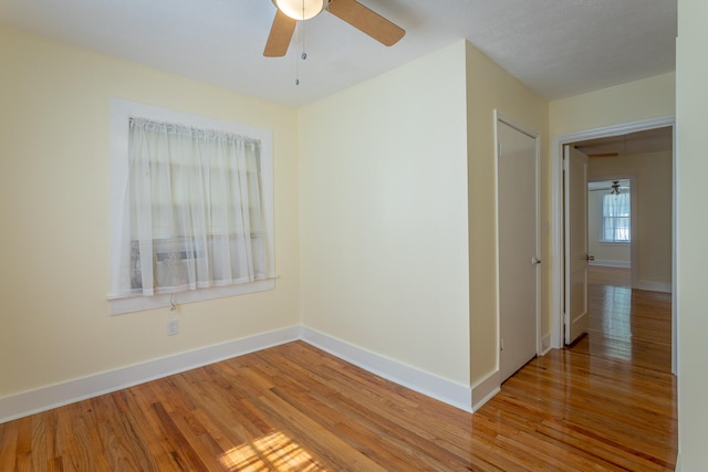 unfurnished room with light hardwood / wood-style flooring and ceiling fan