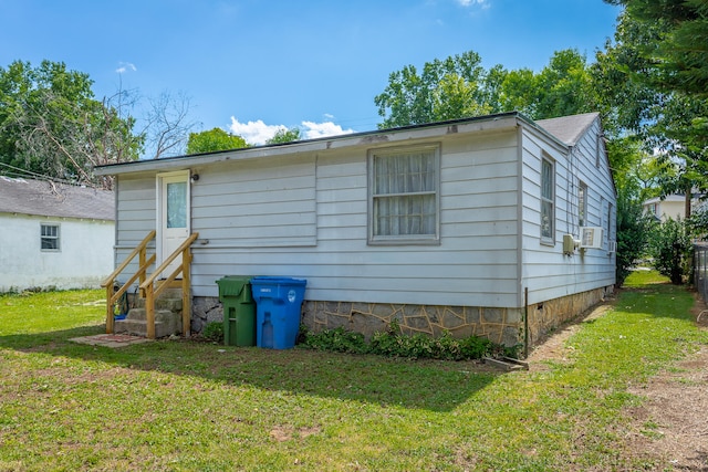 rear view of property featuring a yard