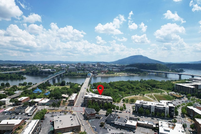 drone / aerial view featuring a water and mountain view