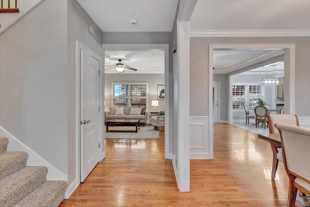 hall featuring light hardwood / wood-style floors and ornamental molding