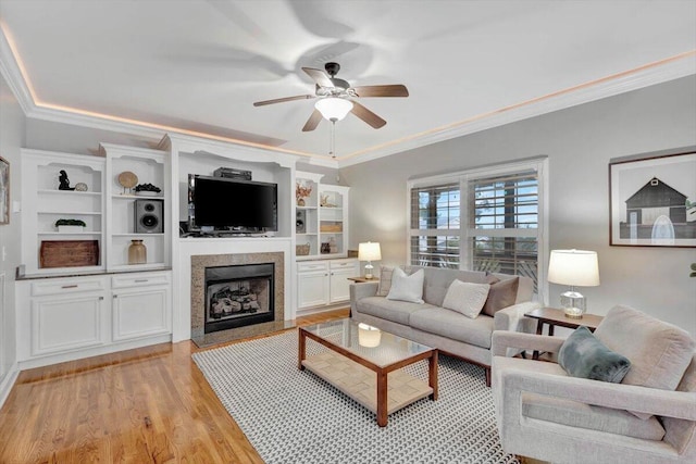 living room featuring ceiling fan, light hardwood / wood-style flooring, and ornamental molding