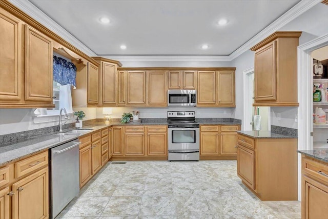 kitchen featuring appliances with stainless steel finishes, dark stone countertops, crown molding, and sink