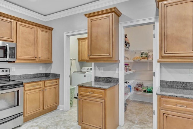 kitchen featuring washer and clothes dryer, dark stone countertops, ornamental molding, and appliances with stainless steel finishes