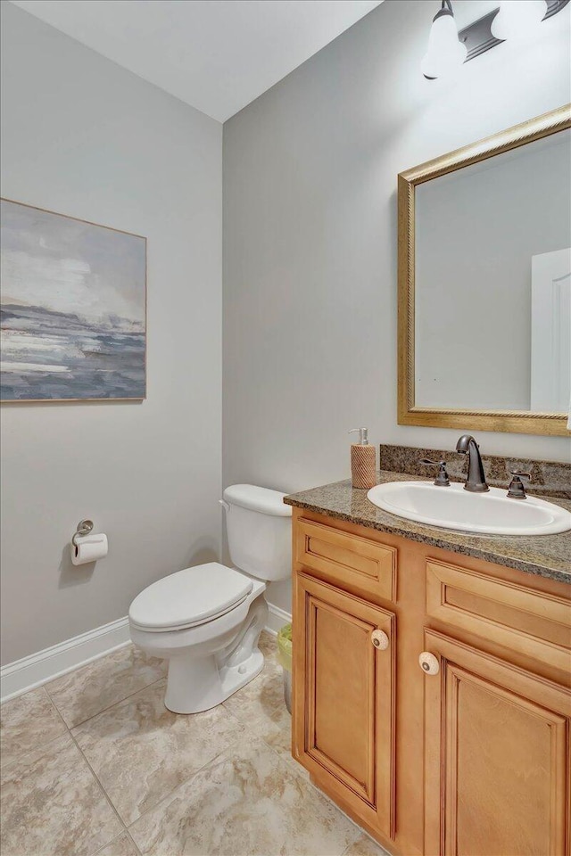 bathroom with tile patterned floors, vanity, and toilet