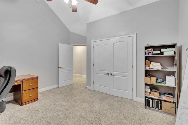 home office with ceiling fan, light colored carpet, and lofted ceiling