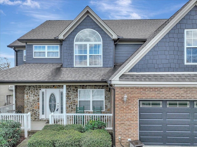 view of front of property with covered porch and a garage