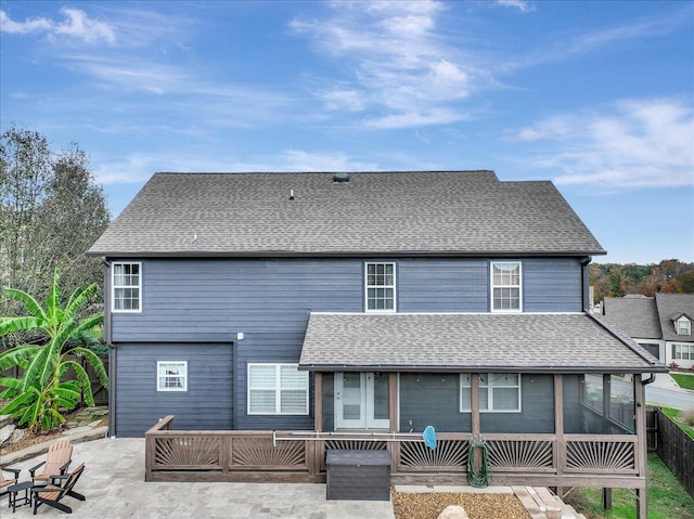 rear view of house featuring a sunroom and a patio area