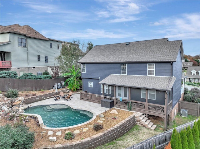 back of house with a fenced in pool, central air condition unit, and a patio