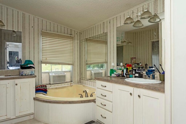 bathroom with a tub to relax in, cooling unit, vaulted ceiling, a textured ceiling, and vanity