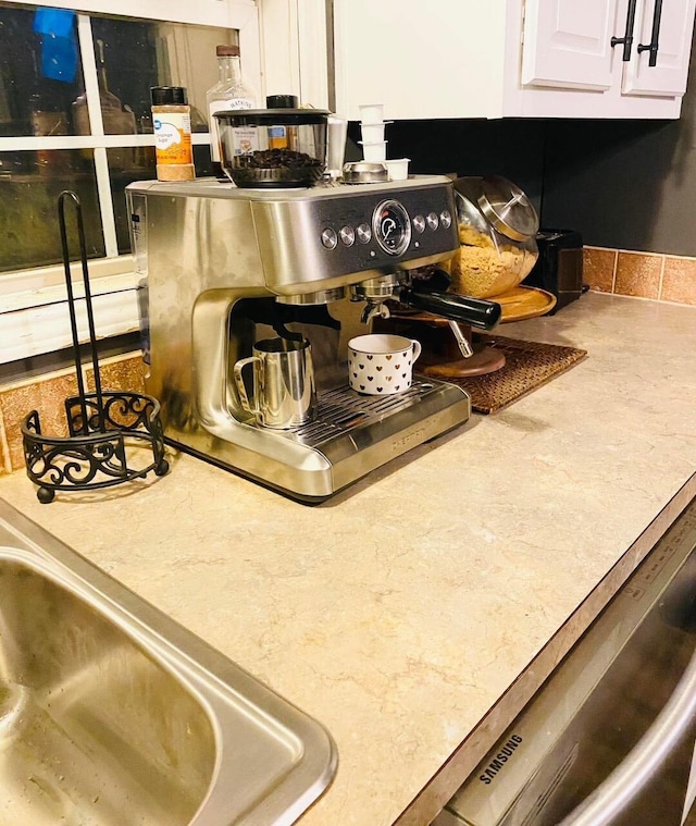 room details featuring sink and white cabinets