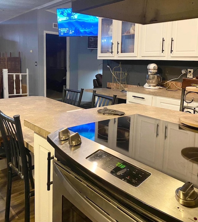 kitchen with hardwood / wood-style flooring and white cabinetry