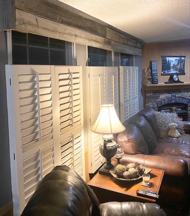 living room with a textured ceiling and wood walls