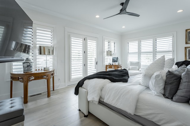 bedroom featuring multiple windows, light hardwood / wood-style floors, ceiling fan, and crown molding