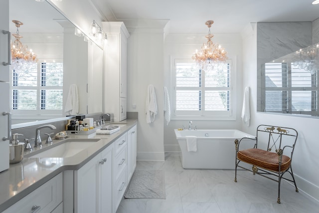 bathroom featuring a bathtub, ornamental molding, vanity, and an inviting chandelier