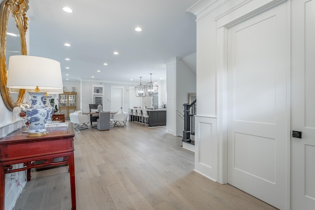 interior space with light hardwood / wood-style floors and a notable chandelier