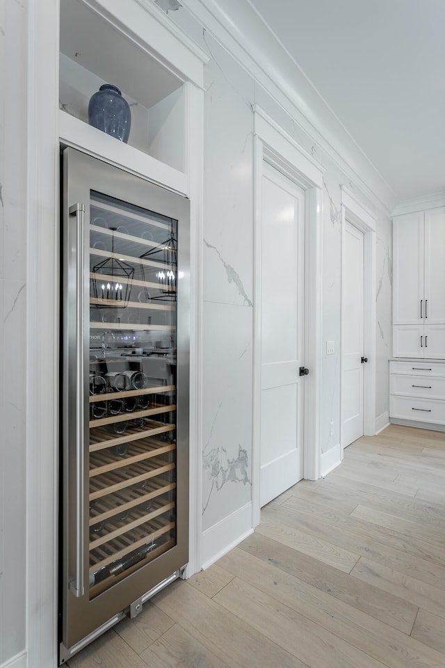 interior space with light hardwood / wood-style floors and beverage cooler