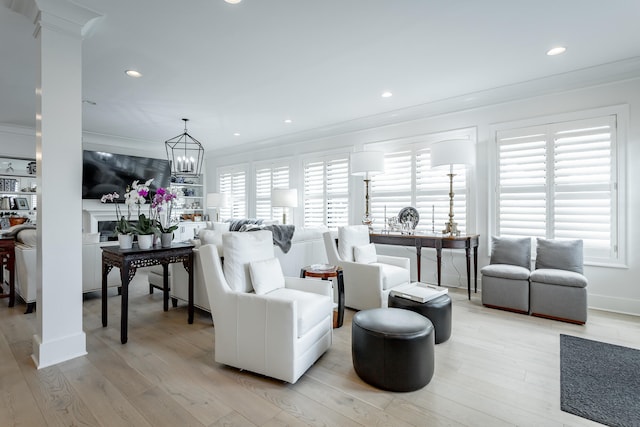 living room featuring light hardwood / wood-style floors, plenty of natural light, and crown molding