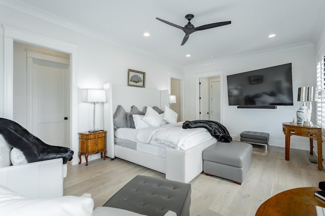 bedroom featuring ceiling fan, ornamental molding, and light wood-type flooring