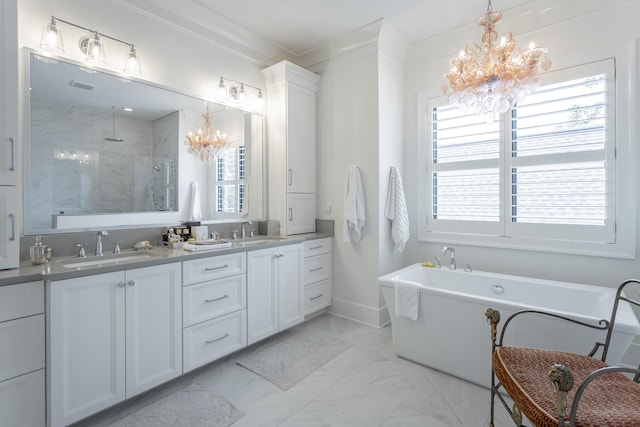 bathroom with plenty of natural light, ornamental molding, and a notable chandelier