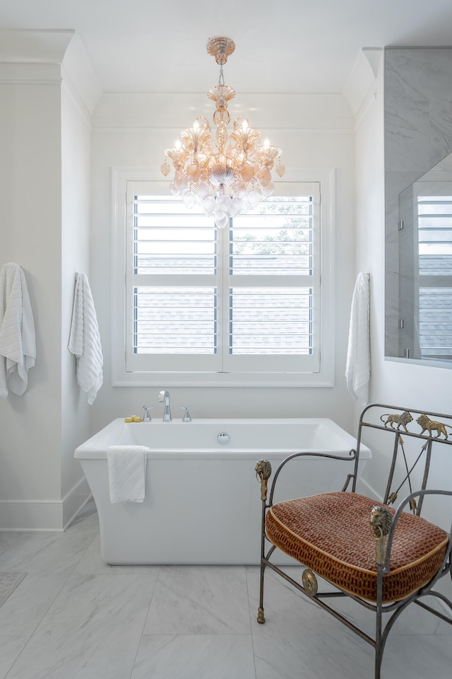 bathroom with crown molding, a bathtub, and a chandelier