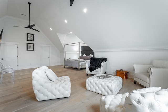 interior space with ceiling fan, light hardwood / wood-style floors, and lofted ceiling