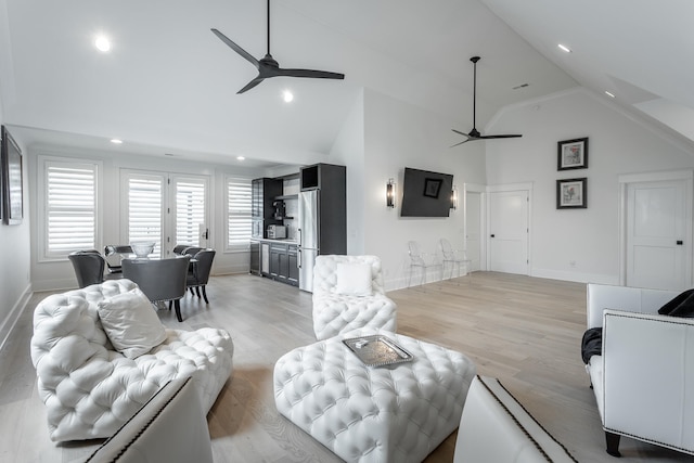 living room with light hardwood / wood-style floors and high vaulted ceiling