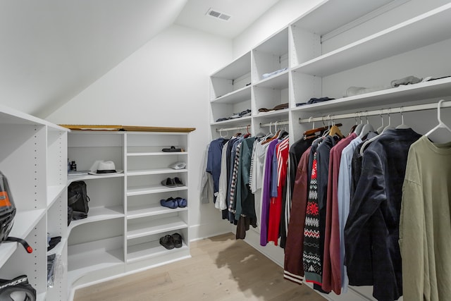 walk in closet featuring lofted ceiling and light wood-type flooring