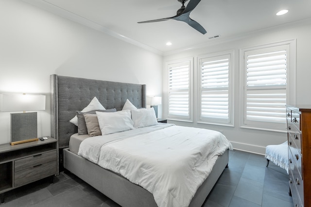 bedroom with multiple windows, dark tile patterned flooring, ceiling fan, and ornamental molding