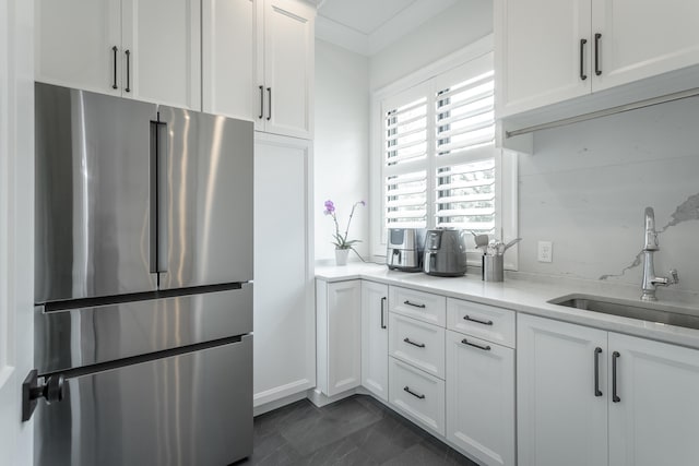 kitchen with white cabinets, stainless steel fridge, and sink