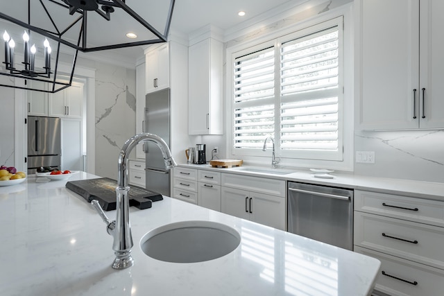 kitchen featuring backsplash, white cabinets, sink, crown molding, and stainless steel appliances