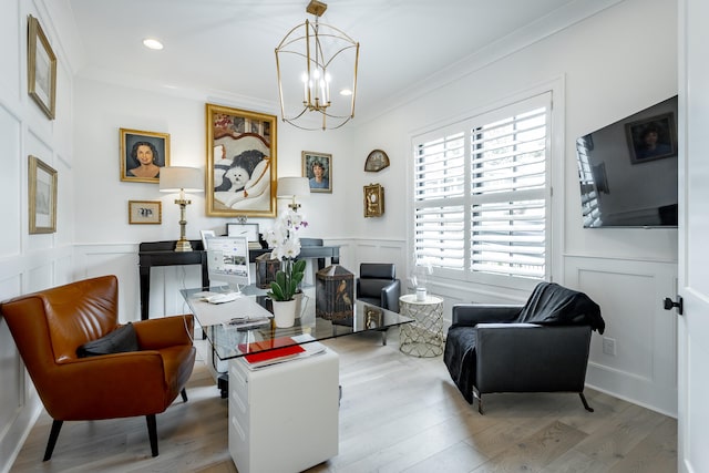 sitting room featuring a notable chandelier, light hardwood / wood-style floors, and ornamental molding