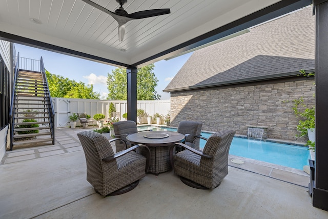 view of patio / terrace featuring pool water feature, a fenced in pool, and ceiling fan