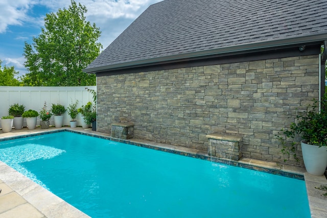 view of swimming pool with pool water feature