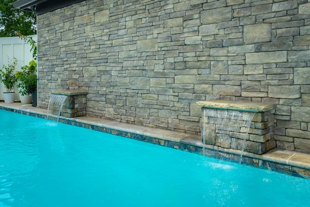 view of pool featuring pool water feature